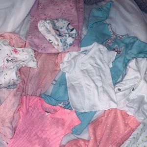 Overflowing box full of NEWBORN baby girl clothes.